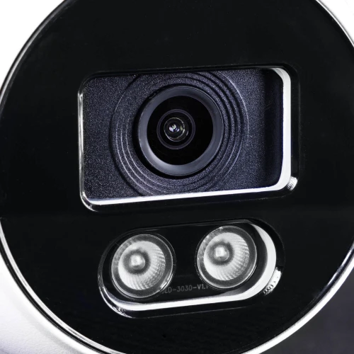 Zbliżenie na obiektyw kamery kopułowej IP z widocznymi dwoma diodami LED poniżej. Kamera ma czarną obudowę z elementami metalicznymi.