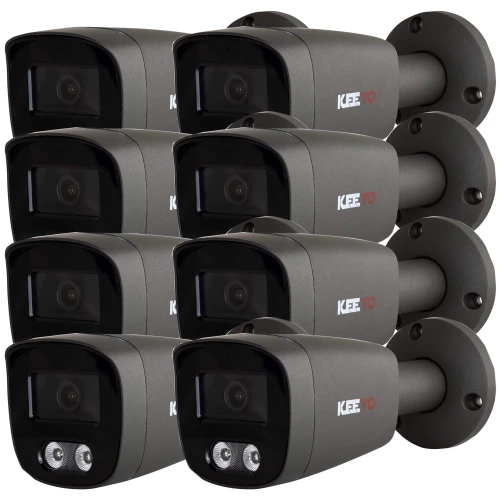 Zdjęcie przedstawia zestaw ośmiu czarnych kamer tubowych zamontowanych na ciemnoszarych uchwytach. Kamery są ustawione w dwóch rzędach, każda z widocznym obiektywem i diodami LED.