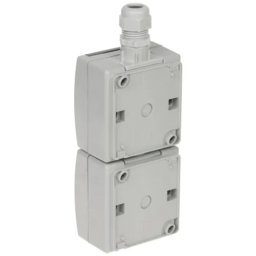 Zdjęcie przedstawia szary, podwójny moduł elektryczny z widocznymi oznaczeniami montażowymi na przedniej stronie. Na górze modułu znajduje się plastikowy dławik kablowy.