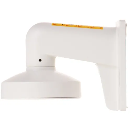 Biały uchwyt montażowy do kamery, widoczny z boku, z prostokątną podstawą i zaokrąglonym ramieniem. Na górnej części uchwytu znajduje się żółta naklejka z czarnymi symbolami.