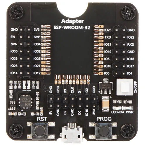 Zdjęcie przedstawia adapter ESP-WROOM-32 z widocznymi pinami i oznaczeniami na czarnym tle. Na płytce znajdują się przyciski RST i PROG oraz przełącznik ON/OFF.