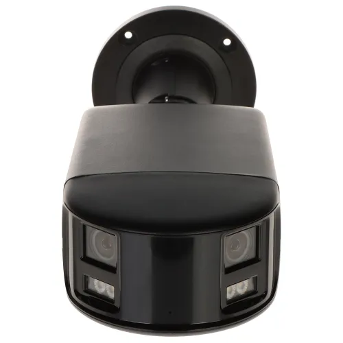 Na zdjęciu znajduje się czarna kamera monitoringu z dwoma obiektywami i wbudowanymi diodami LED, zamontowana na okrągłej podstawie. Kamera ma nowoczesny, kompaktowy design i jest skierowana w stronę obiektywu aparatu.