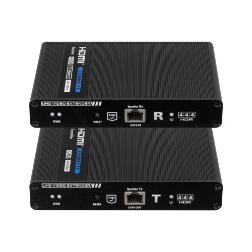 Na zdjęciu znajdują się dwa czarne konwertery HDMI z oznaczeniami "UHD Video Extender" i portami sieciowymi. Urządzenia są ułożone jedno na drugim, a na ich powierzchni widoczne są różne złącza i napisy techniczne.